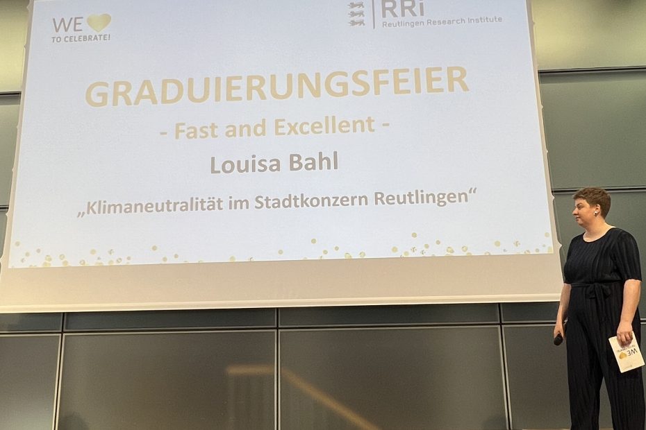 Louisa Bahl steht rechts vor einer präsentierten PowerPoint-Folie, die ihren dreiminütigen Pitch über das Klima-RT-LAB ankündigt.